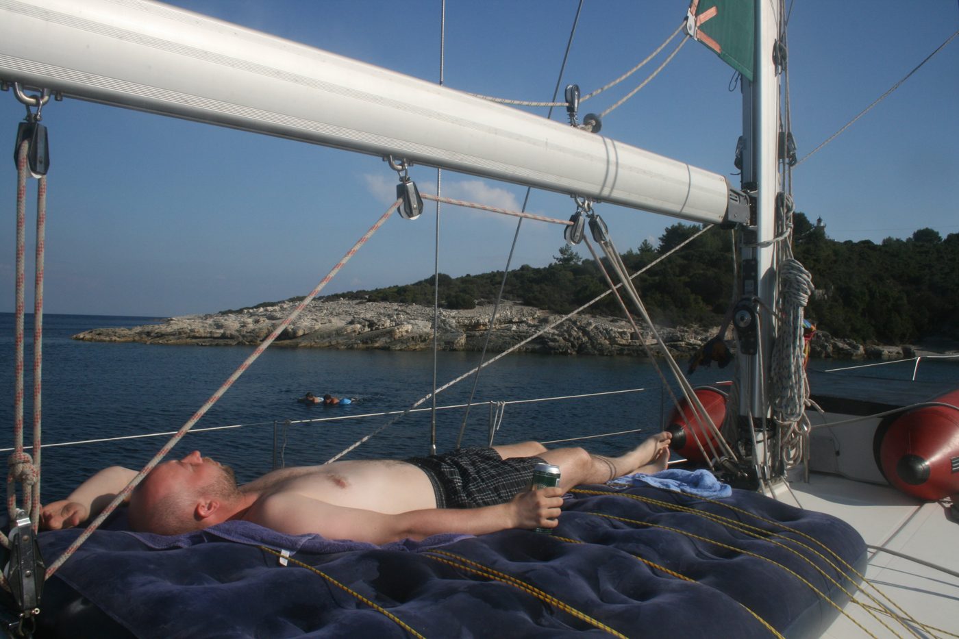 Resting on the bow of a sailing yacht