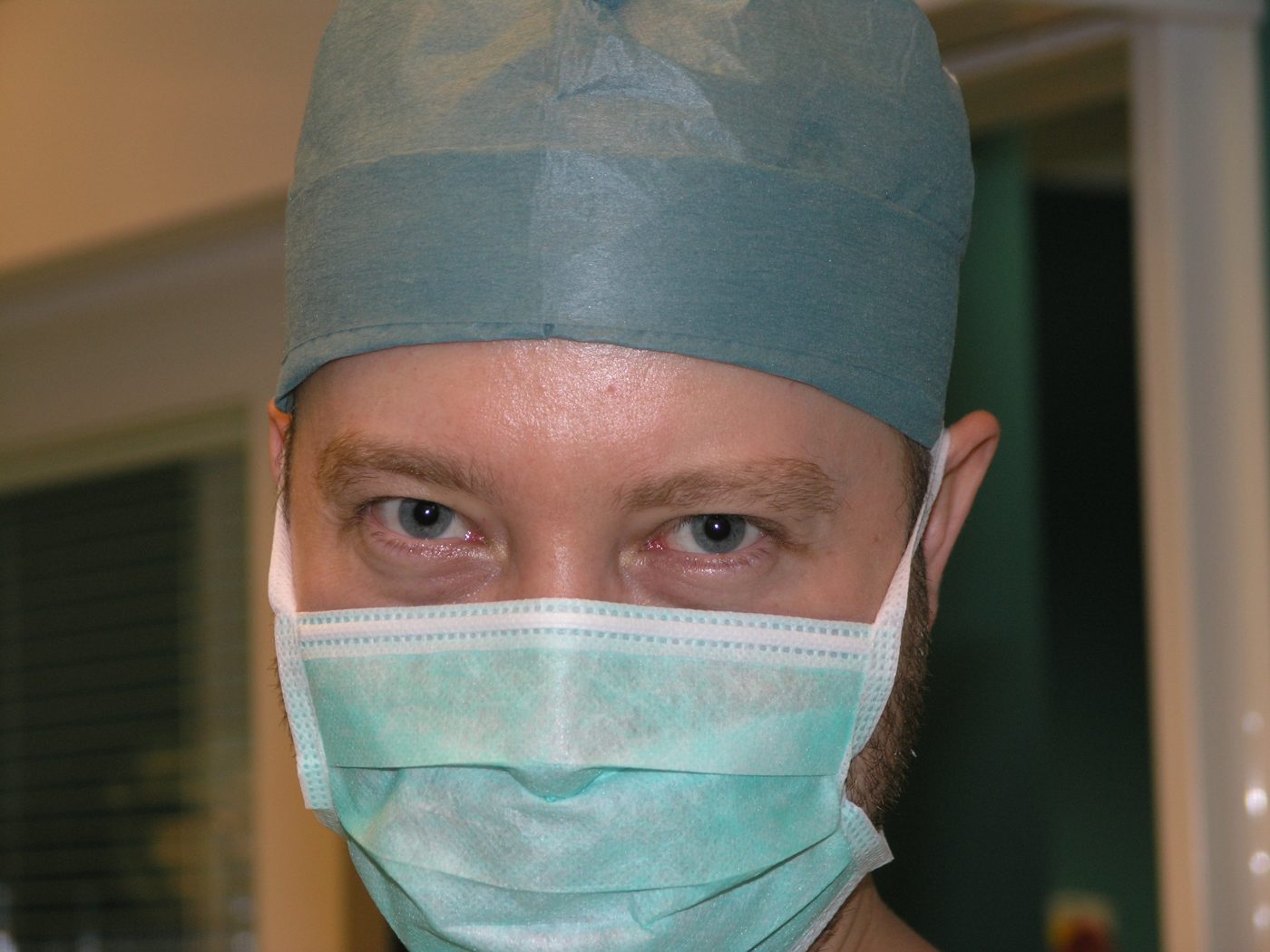 Portrait in a surgical cap and mask
