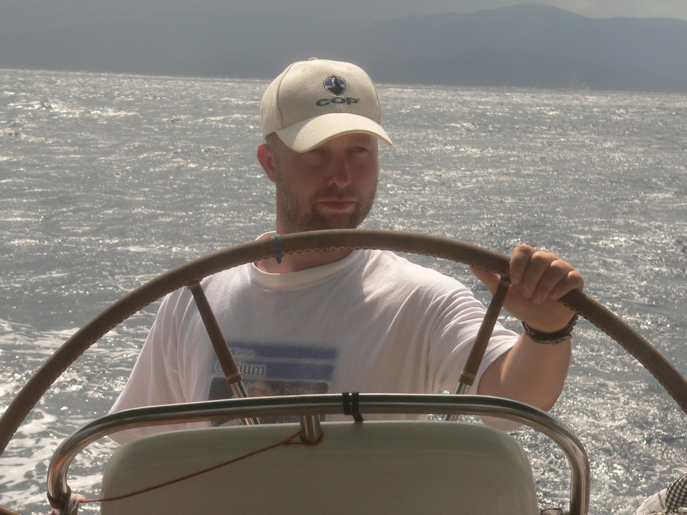 At the helm of a sailing yacht in rough sea
